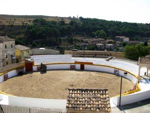 a large amphitheater with a dirt arena in a city at Hostal Rural Los Telares in Pastrana