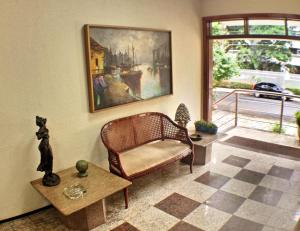 a living room with a couch and a picture on the wall at Aldeota Praia Hotel in Fortaleza