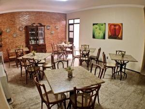 a restaurant with tables and chairs in a room at Aldeota Praia Hotel in Fortaleza
