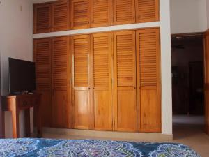 a bedroom with wooden cabinets and a bed at Hacienda Escondida Puerto Vallarta in Puerto Vallarta
