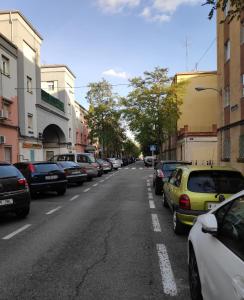 a city street with cars parked on the side of the road at 21 Gumers in Madrid