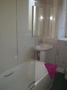 a bathroom with a sink and a bath tub and a sink at No 9 The Guest House Perth in Perth
