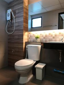 a bathroom with a toilet and a sink at Tata House in Bangkok