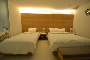 En eller flere senge i et værelse på Sorae Hotel CACAO