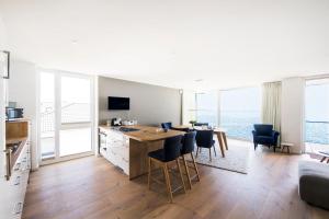 a kitchen and living room with a table and chairs at Wind und Wasser in Olpenitz