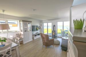 a living room with a kitchen and a dining room at Vogelvilla in Olpenitz