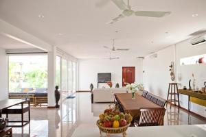 a living room with a table with a bowl of fruit at Angkor Private villa Siem Reap in Siem Reap