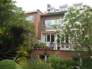 a brick building with potted plants on a balcony at B&B Chambre Chocolat in Brussels