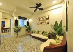 a living room with couches and a ceiling fan at Down South Hostel in Cebu City