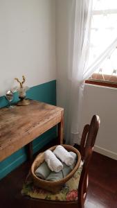 a room with a wooden table and a wooden chair with towels at DoubleTree House in Chiang Mai