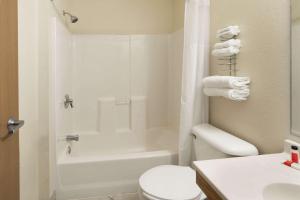 La salle de bains est pourvue de toilettes blanches et d'un lavabo. dans l'établissement Super 8 by Wyndham Fountain, à Fountain