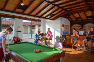 a group of people sitting around a pool table at Mermaid Hotel & Club in Kalutara
