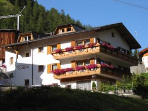 a white building with flowers on the balconies at Appartements Hotel-Garni Dolce Vita in Samnaun