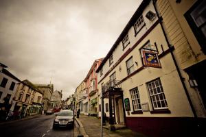 a car parked on a street next to a building at The Angel Hotel in Helston