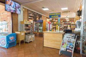 a grocery store aisle with a grocery store with a counter at Hotel-Restaurante La Sima in Castillo de Garcimuñoz