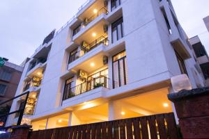 a white building with windows and a fence at Stay@ in Bangalore