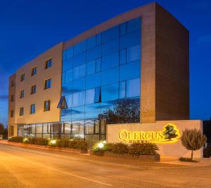 a building with a sign in front of it at Hotel Quercus in Međugorje