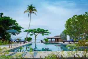 a swimming pool with a view of the ocean at Deshadan Backwater Resort - The best sunrise view in Alleppey