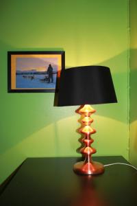 a lamp sitting on top of a wooden table at Abisko net Hostel & Huskies in Abisko