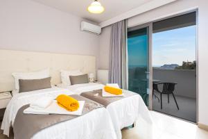 Posteľ alebo postele v izbe v ubytovaní Sunset Maisonettes