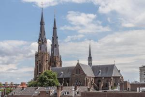 a large cathedral with two spires on top of a building at Boutique Hotel Lumiere in Eindhoven