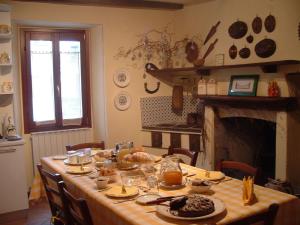 a table with food on it in a room with a fireplace at La Ca' Di Sala in Margno