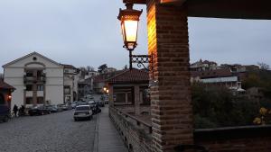 a street light on the side of a brick building at MANGO Guesthouse in Sighnaghi