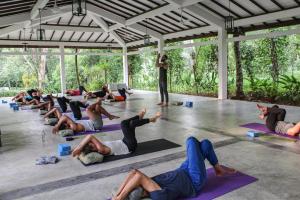 a group of people in a yoga class at Plantation Villa in Kalutara