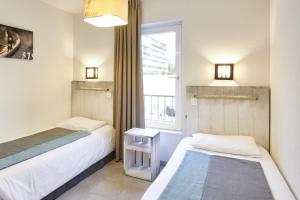 Кровать или кровати в номере Résidence Vacances Bleues Les Jardins d'Arvor
