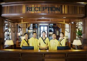 a group of people standing in front of a counter at Le Bel Air Resort Luang Prabang in Luang Prabang +59 photos