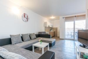 a living room with a couch and a table at Pasko 4 modern furnished ap for 7 in Novalja