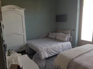 Postel nebo postele na pokoji v ubytování L'Ortodellerose