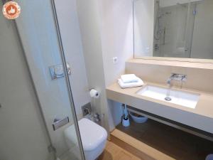 a bathroom with a toilet and a sink and a mirror at ALC - VC3 - 7 min Palais and 3 min Beaches in Cannes