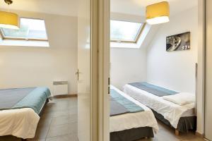 Кровать или кровати в номере Résidence Vacances Bleues Les Jardins d'Arvor