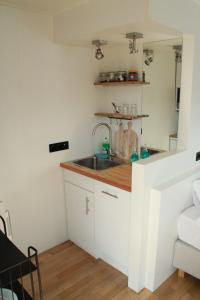 a kitchen with a sink and a counter at Houseboat Studio Sooki in Amsterdam