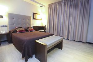 Postel nebo postele na pokoji v ubytování Hotel Torre de Núñez