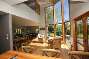 a living room with a table and chairs at On The River in Hamilton