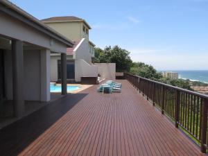 
a view from a balcony of a building with a view of the ocean at Alante Lodge in Amanzimtoti
