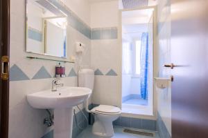 a bathroom with a sink and a toilet and a mirror at Legends in Rome