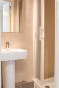 uma casa de banho com um lavatório e um chuveiro em Hotel Boronali em Paris