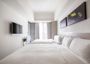 Letto o letti in una camera di CityInn Hotel Plus- Fuxing North Road Branch