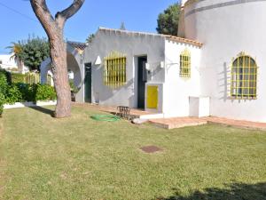 a white house with a tree in the yard at Tranquil Villa in Vilamoura with Private Swimming Pool in Vilamoura