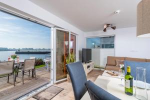 a living room with a view of the water at DreamLounge in Olpenitz