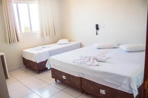 Postel nebo postele na pokoji v ubytování Hotel Colina