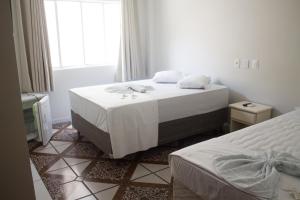 Postel nebo postele na pokoji v ubytování Hotel Colina