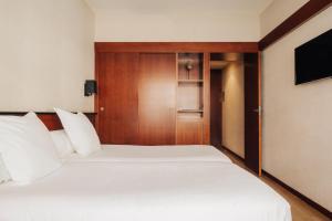 
מיטה או מיטות בחדר ב-Hotel Derby
