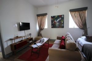 a living room with a couch and a table at 86 on Jubilee in Oudtshoorn