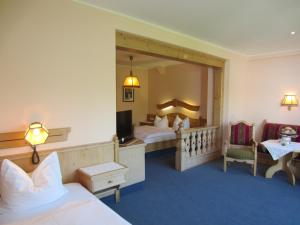 a hotel room with a bed and a large mirror at Hotel Plainbrücke | self check-in in Salzburg