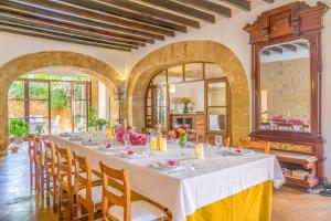 a dining room with a long table and chairs at Historic House in Mallorca Up To 12 Guests in Andratx