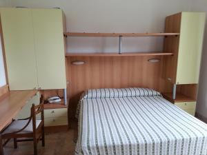 Postel nebo postele na pokoji v ubytování Hotel Nel Pineto